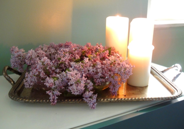 A tray of lilacs and candles